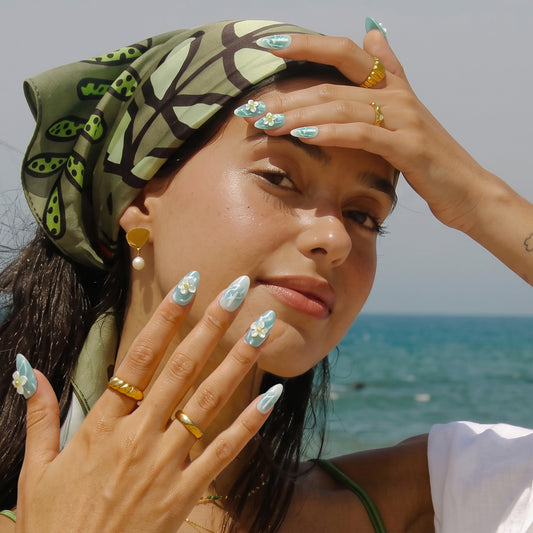 Model wearing Mint Waterlily green floral press on nails